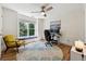 This home office features a large window, wood floors, and a comfortable work area at 302 Shawnee Indian Ln, Suwanee, GA 30024