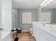 Bright bathroom featuring double sinks, wood look flooring, and modern fixtures for a spa-like experience at 332 Heavenly Hollow Pl, Mcdonough, GA 30253