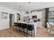 Kitchen island with white countertops, stylish barstools, and stainless steel appliances in a modern design at 332 Heavenly Hollow Pl, Mcdonough, GA 30253
