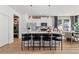 Modern kitchen island with white countertops, stainless steel appliances, and bar stools for seating at 332 Heavenly Hollow Pl, Mcdonough, GA 30253