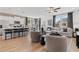 Open-concept living room with modern furnishings, hardwood floors, and a view of the kitchen at 332 Heavenly Hollow Pl, Mcdonough, GA 30253