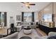 Bright living room with a comfortable sectional sofa, modern decor, and large windows with curtains at 332 Heavenly Hollow Pl, Mcdonough, GA 30253