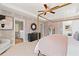 Inviting main bedroom with a four-poster bed, elegant decor, and a view into the en suite bath for added convenience at 332 Heavenly Hollow Pl, Mcdonough, GA 30253