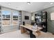 Well-lit home office with a modern desk, stylish shelving, and a view of the outdoors at 332 Heavenly Hollow Pl, Mcdonough, GA 30253