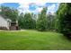 Lush backyard featuring a spacious lawn, a wooden deck with stairs, and a patio area perfect for outdoor entertaining at 3600 Morishop Nw Cv, Marietta, GA 30064
