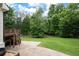 Lush backyard featuring a spacious lawn, a wooden deck with stairs, and a patio area perfect for outdoor entertaining at 3600 Morishop Nw Cv, Marietta, GA 30064