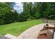 Well-maintained backyard with lush green grass, mature trees, and wooden fencing at 3600 Morishop Nw Cv, Marietta, GA 30064