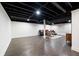 Finished basement showcasing a dark ceiling, light walls, and hardwood floors at 3600 Morishop Nw Cv, Marietta, GA 30064