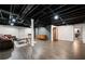 Finished basement with dark exposed ceiling, wood floors, white walls, and comfortable seating area at 3600 Morishop Nw Cv, Marietta, GA 30064
