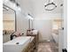 Bright bathroom featuring double vanities, vessel sinks, standalone tub, and unique light fixture at 3600 Morishop Nw Cv, Marietta, GA 30064