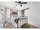 Bright bedroom with metal bedframe, neutral walls, and sliding barn door at 3600 Morishop Nw Cv, Marietta, GA 30064