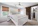 Cozy bedroom with white furniture, carpet, sliding barn door, and natural light at 3600 Morishop Nw Cv, Marietta, GA 30064