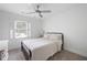 Well-lit bedroom featuring neutral walls, carpet, and a simple metal bedframe at 3600 Morishop Nw Cv, Marietta, GA 30064