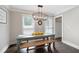 Cozy dining room with rustic table, bench seating, and ample natural light at 3600 Morishop Nw Cv, Marietta, GA 30064