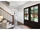 Inviting foyer with dark hardwood floors, staircase, and a decorative rug at 3600 Morishop Nw Cv, Marietta, GA 30064