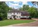 Beautiful two-story home featuring a well-maintained lawn, mature trees, and a classic, symmetrical design at 3600 Morishop Nw Cv, Marietta, GA 30064
