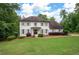 Charming two-story white brick home with grey shutters, mature landscaping, and a well-manicured lawn at 3600 Morishop Nw Cv, Marietta, GA 30064