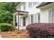 Charming front entrance with white columns, decorative bushes, and a well-maintained garden bed at 3600 Morishop Nw Cv, Marietta, GA 30064