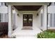 Covered front porch of white brick home featuring classic columns and a welcome mat at 3600 Morishop Nw Cv, Marietta, GA 30064
