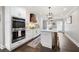 Bright kitchen with white cabinetry, stainless steel appliances, and hardwood floors at 3600 Morishop Nw Cv, Marietta, GA 30064