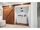 Laundry room with a sliding barn door and full size washer and dryer at 3600 Morishop Nw Cv, Marietta, GA 30064