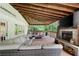 Covered back patio with fireplace, sitting area, and woodland views at 3600 Morishop Nw Cv, Marietta, GA 30064