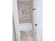 Well-lit bathroom featuring a tub/shower combination with stylish neutral tile and updated fixtures at 4411 Flakes Mill Rd, Ellenwood, GA 30294
