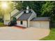 Exterior view of a two-story home with an attached two-car garage and driveway at 4411 Flakes Mill Rd, Ellenwood, GA 30294