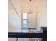 Bright foyer with a modern light fixture and a view of the exterior from the upper level at 4411 Flakes Mill Rd, Ellenwood, GA 30294