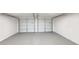 Interior of an attached two-car garage with two doors, freshly painted at 4411 Flakes Mill Rd, Ellenwood, GA 30294
