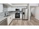 Spacious kitchen featuring stainless steel appliances, granite countertops, and white cabinets at 4411 Flakes Mill Rd, Ellenwood, GA 30294