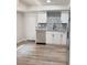 Kitchen with white cabinets, stainless steel appliances, and wood flooring at 4411 Flakes Mill Rd, Ellenwood, GA 30294
