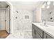 A luxurious bathroom with white marble tiles, a rainfall shower, and a sleek gray vanity at 2331 Luther St, Lithonia, GA 30058