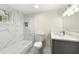 Modern bathroom with marble wall tile, bathtub, and sleek vanity with sink at 2331 Luther St, Lithonia, GA 30058