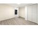 An airy bedroom featuring sleek, gray wood floors, neutral walls, and a closet for optimal storage space at 2331 Luther St, Lithonia, GA 30058