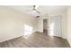 A spacious bedroom featuring sleek floors, neutral walls, a ceiling fan, and a double closet at 2331 Luther St, Lithonia, GA 30058