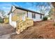 Charming single-story home with new stairs and wooden railing leading to the front door at 2331 Luther St, Lithonia, GA 30058
