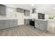 Modern kitchen with gray cabinetry, stainless steel appliances, island, and stylish countertops at 2331 Luther St, Lithonia, GA 30058