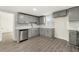 Modern kitchen with gray cabinetry, stainless steel appliances, and hardwood flooring at 2331 Luther St, Lithonia, GA 30058