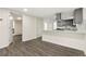 Open concept kitchen with gray cabinets, stainless steel appliances, and stone countertops at 2331 Luther St, Lithonia, GA 30058