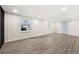 Bright living room with gray floors, multiple windows, and recessed lighting at 2331 Luther St, Lithonia, GA 30058