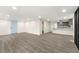Open concept living room with gray floors leading to the kitchen and a blue entry door at 2331 Luther St, Lithonia, GA 30058