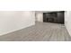 Spacious living room with gray floors and modern electric fireplace with built-in storage at 2331 Luther St, Lithonia, GA 30058