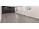 Bright living room with gray floors, electric fireplace and built-in storage, and large windows at 2331 Luther St, Lithonia, GA 30058