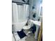 Bathroom with shower over tub, pedestal sink, and marble floors at 3182 Latona Sw Dr, Atlanta, GA 30354