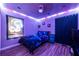 Bedroom with violet lighting, laminate floors, comfortable mattress, and curtains in the window at 3182 Latona Sw Dr, Atlanta, GA 30354