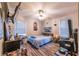 Cozy bedroom featuring a ceiling fan, many windows, and a comfortable bed at 3182 Latona Sw Dr, Atlanta, GA 30354