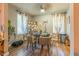 Well-lit dining space with hardwood floors, dining table and chairs, and decorative elements at 3182 Latona Sw Dr, Atlanta, GA 30354