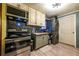 Functional kitchen with stainless steel appliances, colorful backsplash, and convenient washer/dryer setup at 3182 Latona Sw Dr, Atlanta, GA 30354