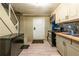 Basement kitchen with appliances, wood countertops, a small sink, mosaic backsplash, and tiled floors at 3182 Latona Sw Dr, Atlanta, GA 30354